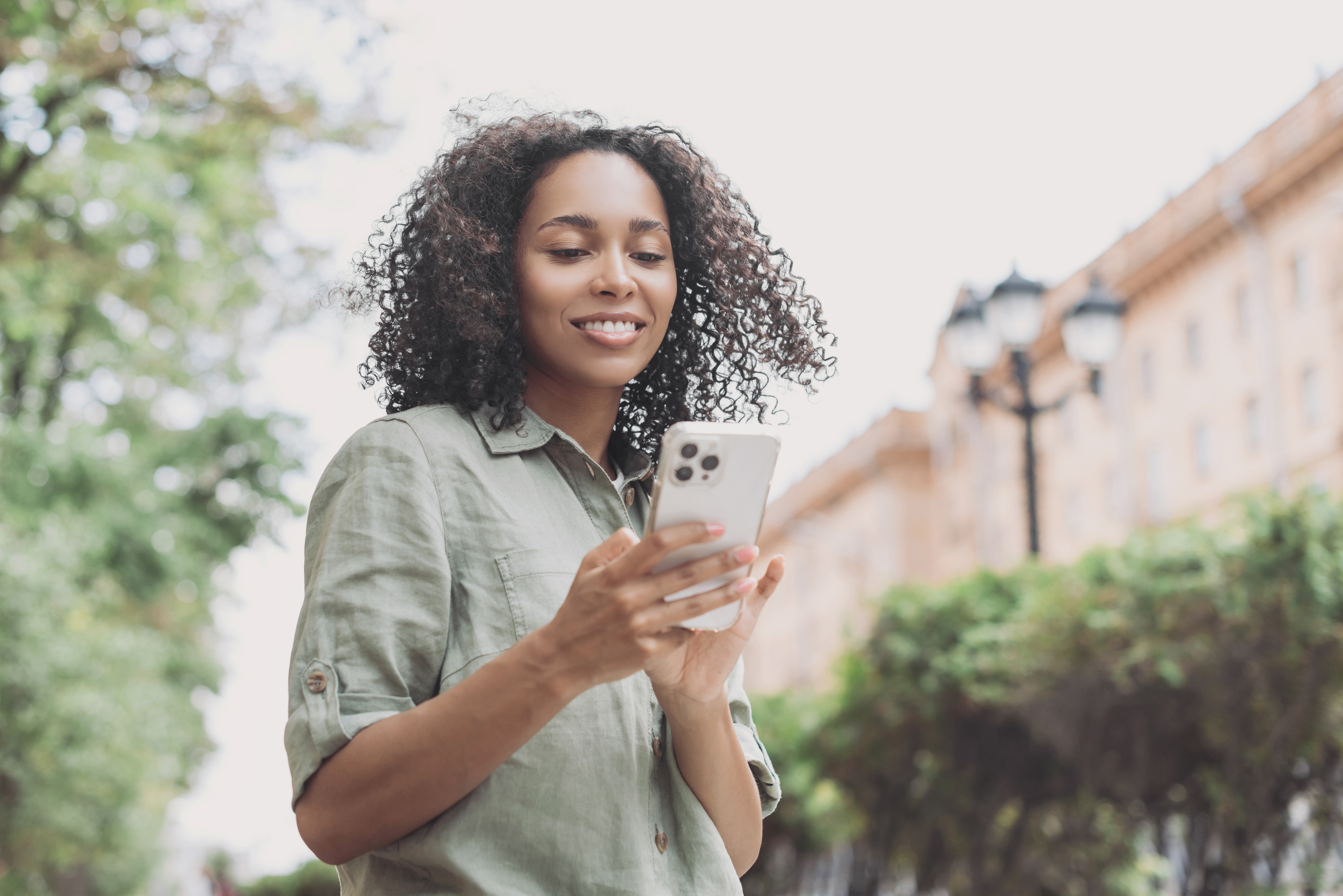 A woman conveniently opens a credit union account from her smartphone.